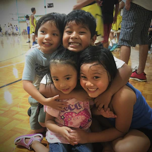A group of young athletes celebrating a basketball victory together, embodying teamwork and joy.