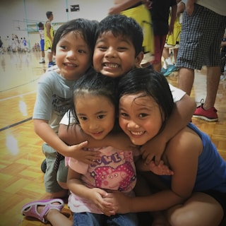 Children celebrating a victorious moment during a basketball game at the Superstars sports school.