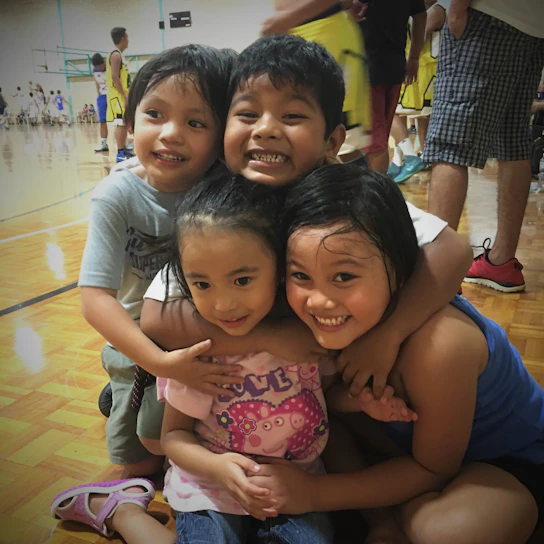A group of young athletes celebrating a basketball victory together, embodying teamwork and joy.