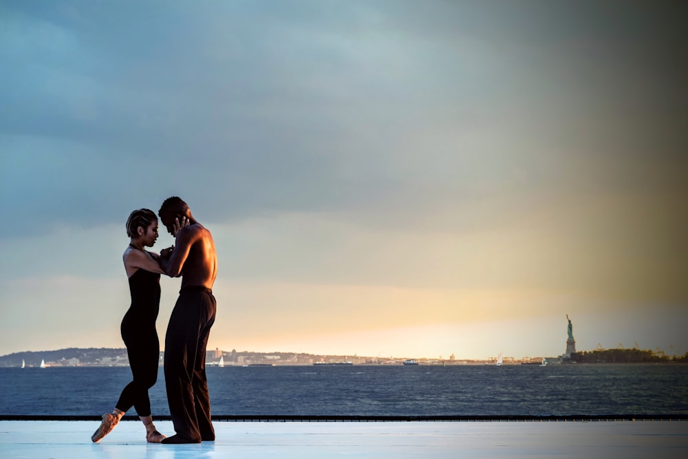 couple standing near body of water during daytime