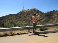 A member tuning their radio while enjoying a scenic mountain hike.