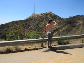 A member tuning their radio while enjoying a scenic mountain hike.