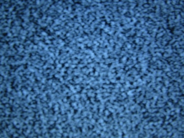 A close-up of blue static noise pattern resembling what might be seen on an old television screen without a signal. The image is uniformly filled with small light and dark blue speckles creating an abstract, textured appearance.