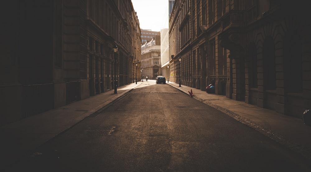 architectural photography of vehicle between two buildings