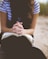 woman sitting on brown bench while reading book