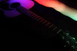 Close-up of zxoe’s distorted guitar with glitchy light trails in the background.