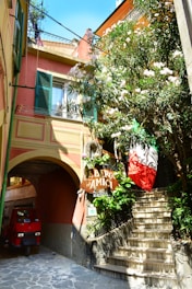 A cozy Italian rental home with a welcoming entrance and vibrant flowers.