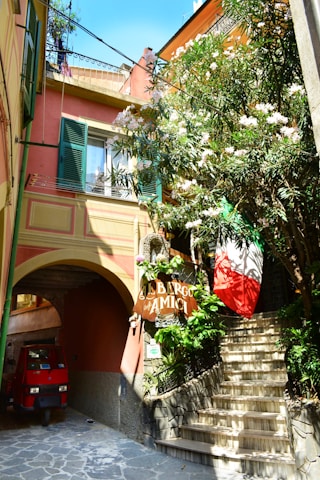 A cozy Italian rental home with a welcoming entrance and vibrant flowers.