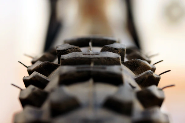 Close-up of a high-quality motorcycle tire with detailed tread pattern under professional lighting