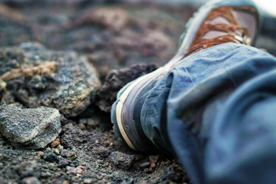 Close-up of the sleek hypershell exoskeleton supporting a person’s legs on a rocky mountain path