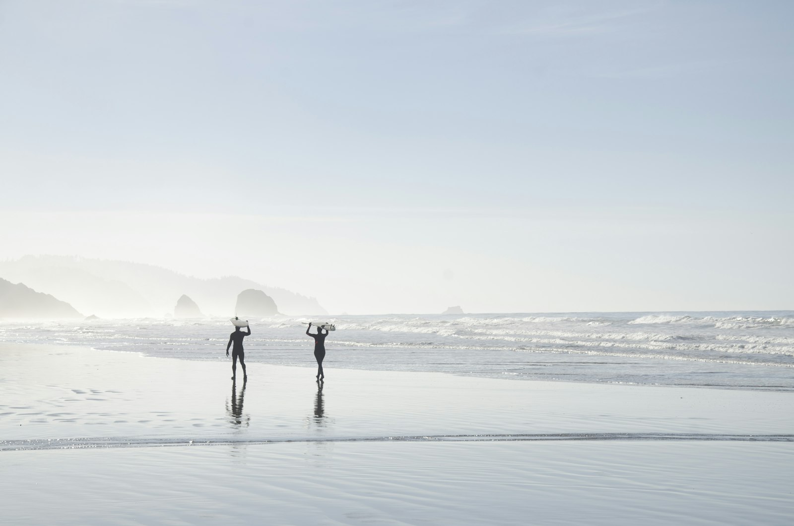 Nikon D7000 + Nikon AF-S DX Nikkor 18-300mm F3.5-5.6G ED VR sample photo. Two men carrying surfboards photography