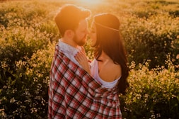 man hugging woman surrounded by plants