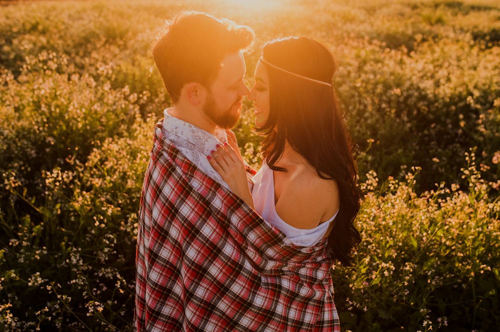 man hugging woman surrounded by plants