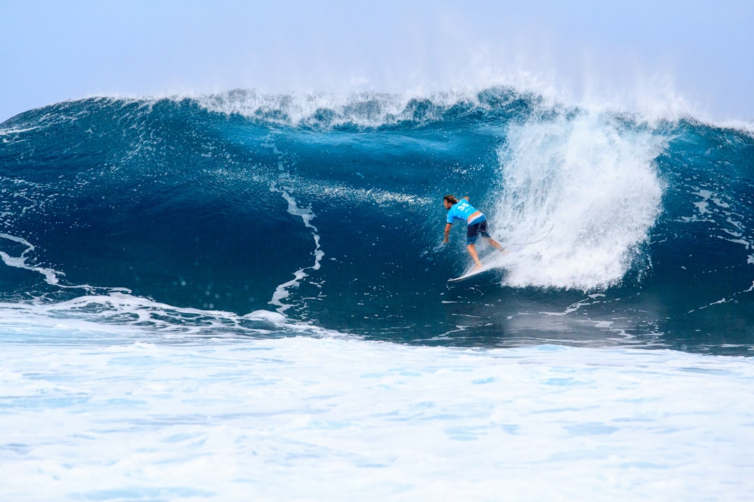 surfer surfing on tidal wave, Surfing in the blue
