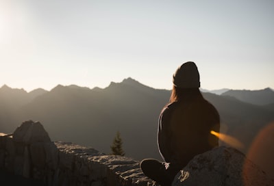 person wearing knit cap facing mountain view google meet background