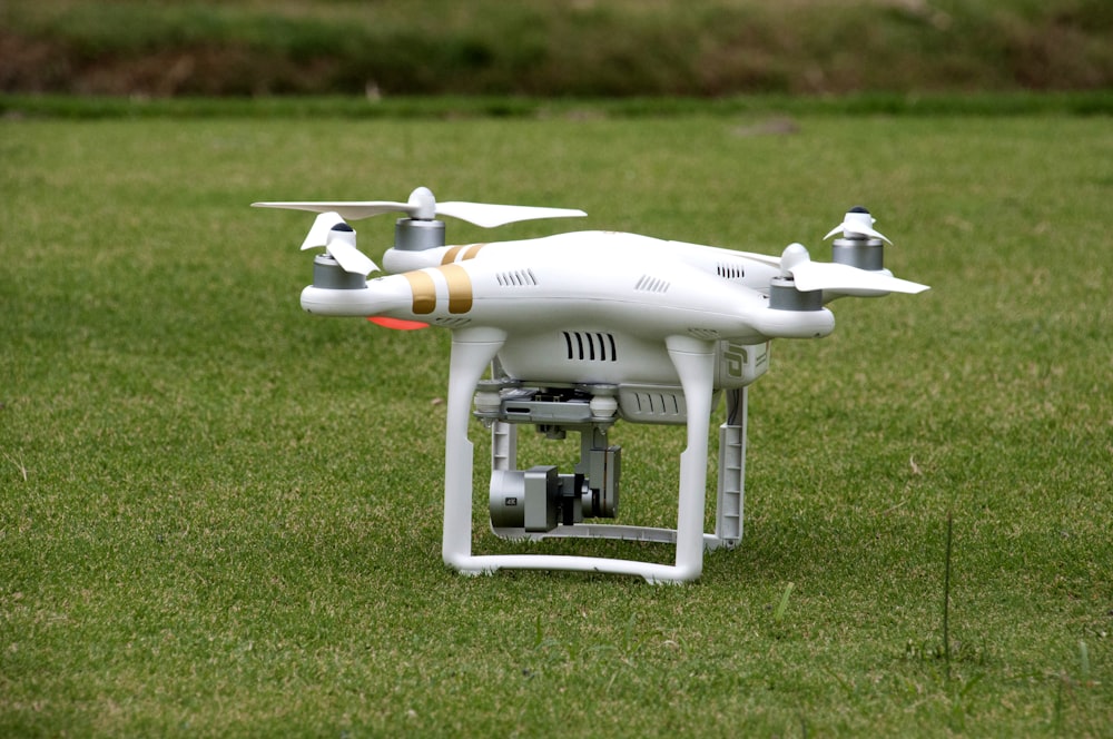 white quadcopter on lawn