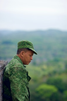 A thoughtful veteran walking near a city park reflecting on new beginnings after military service.