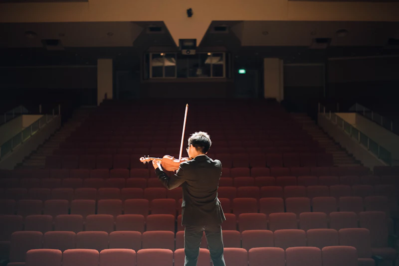 Violinist playing on an empty concert stage