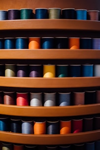 Colorful assortment of sewing threads and buttons neatly arranged on display shelves