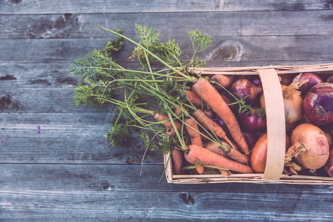 carrots and onions in brown wicker basket