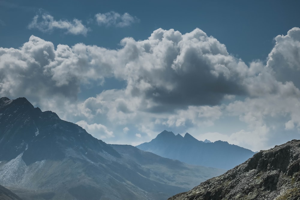 green mountains under white clouds and blue sky during daytime