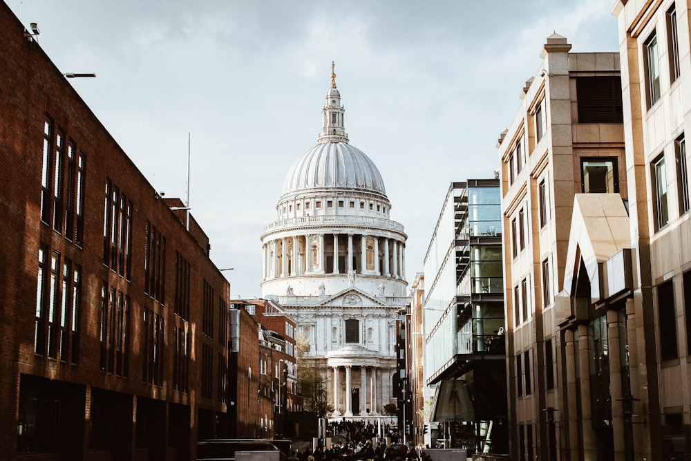 white building with dome under white clouds during daytime