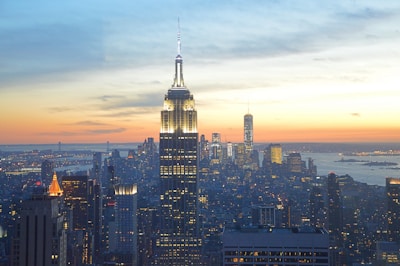 A bustling city skyline at sunset with colorful lights.