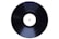 A black vinyl record with a plain white label in the center is displayed at a slight angle against a white background.