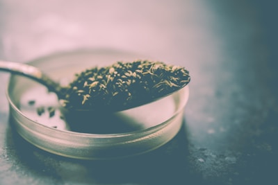 Close-up of sesame seeds in a ceramic bowl with soft shadows.