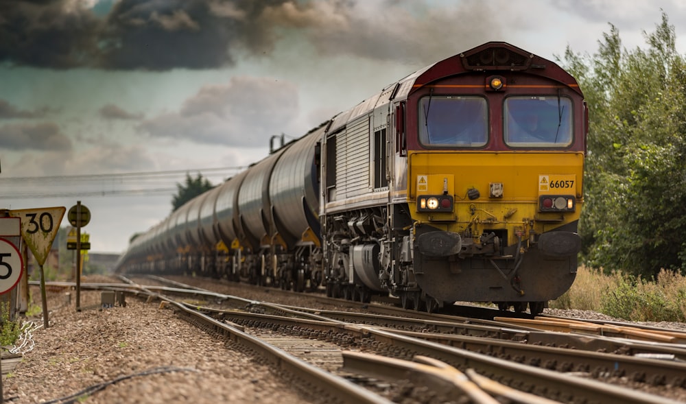 yellow and black train on railways