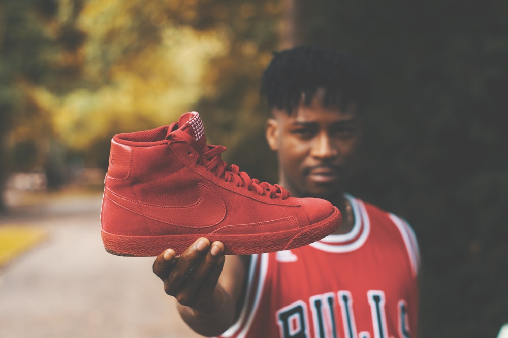 man showing red Nike high-top sneaker