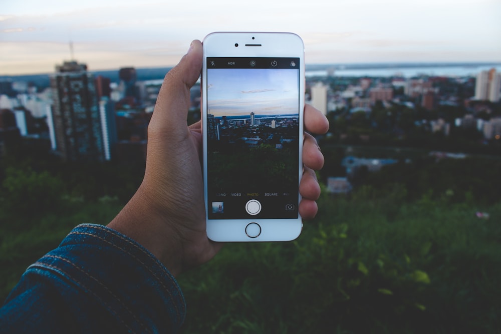 person taking picture of buildings