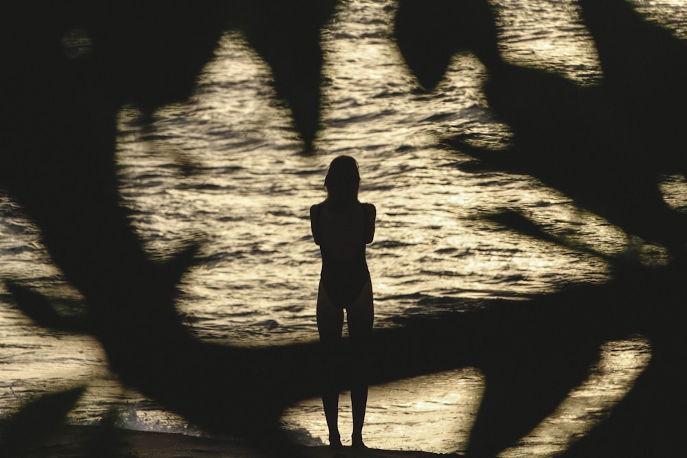 photo of person standing near body of water