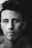 grayscale photo of man smiling looking at camera