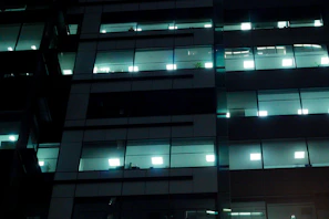 Nighttime view of a modern office space with gleaming surfaces and calm atmosphere