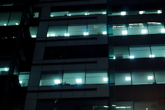 Nighttime view of a modern office space with gleaming surfaces and calm atmosphere
