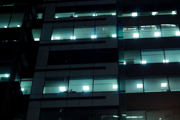Nighttime view of a professional cleaning team working inside a modern office building in Reno.