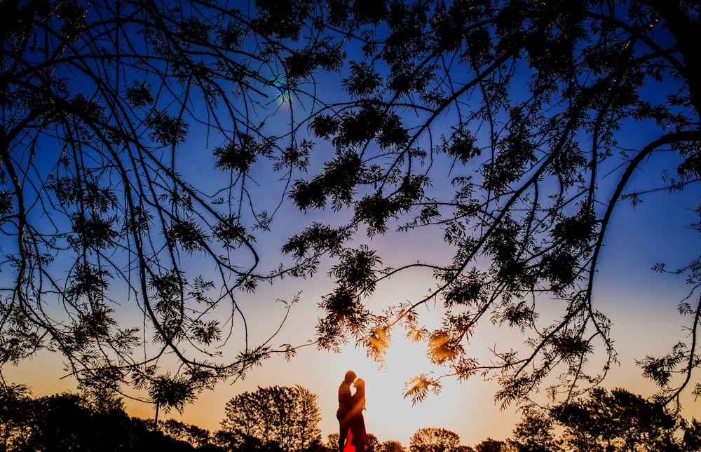 silhouette photo of man and woman hugging each other