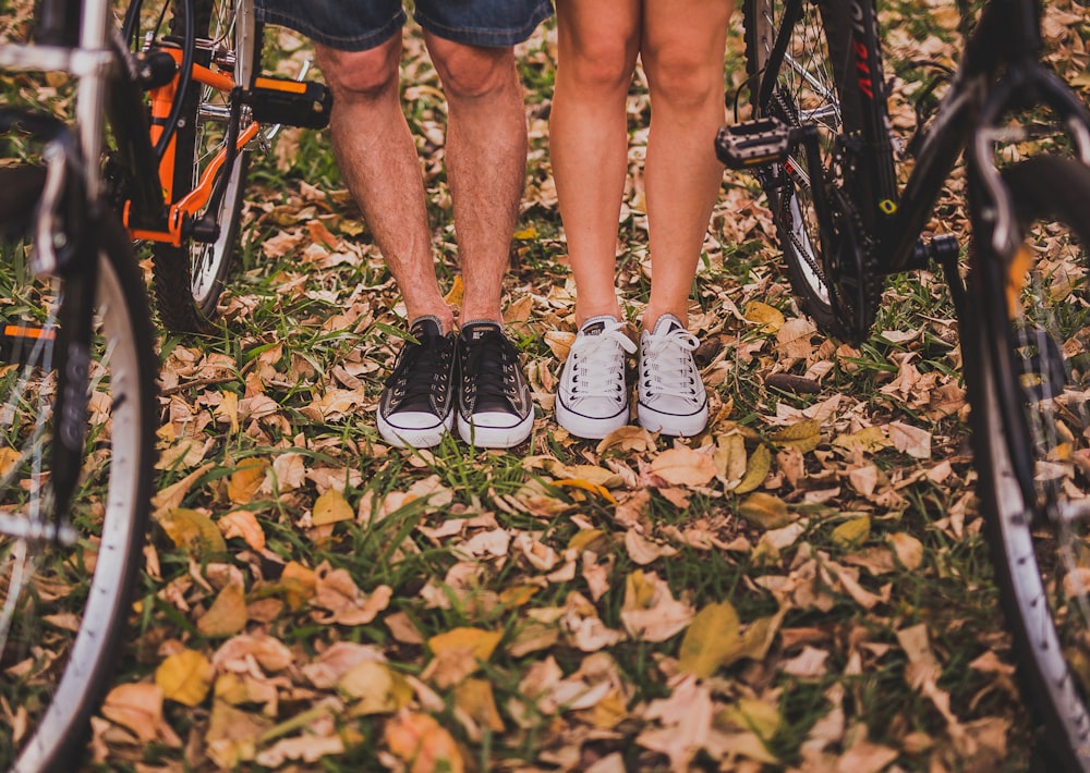 two person standing between mountain bikes