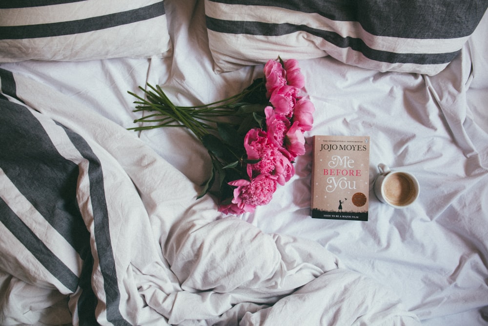 bouquet of pink flowers on top of bed