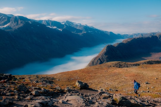 person walking on mountain in Besseggen Norway