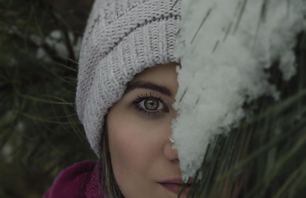 woman's face covered by green plant