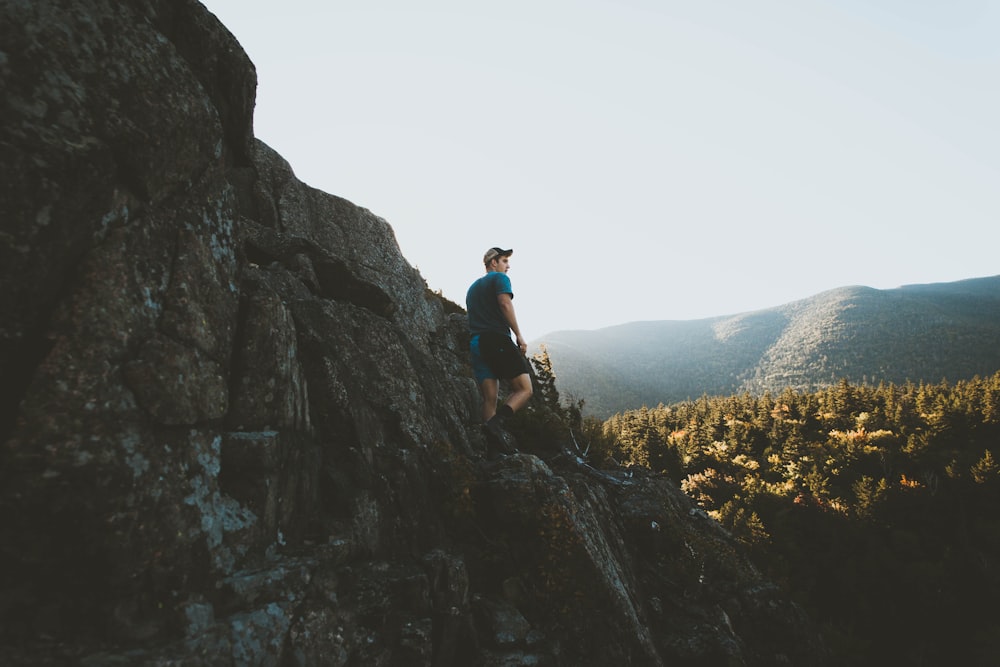 Mann steht auf Bergklippe