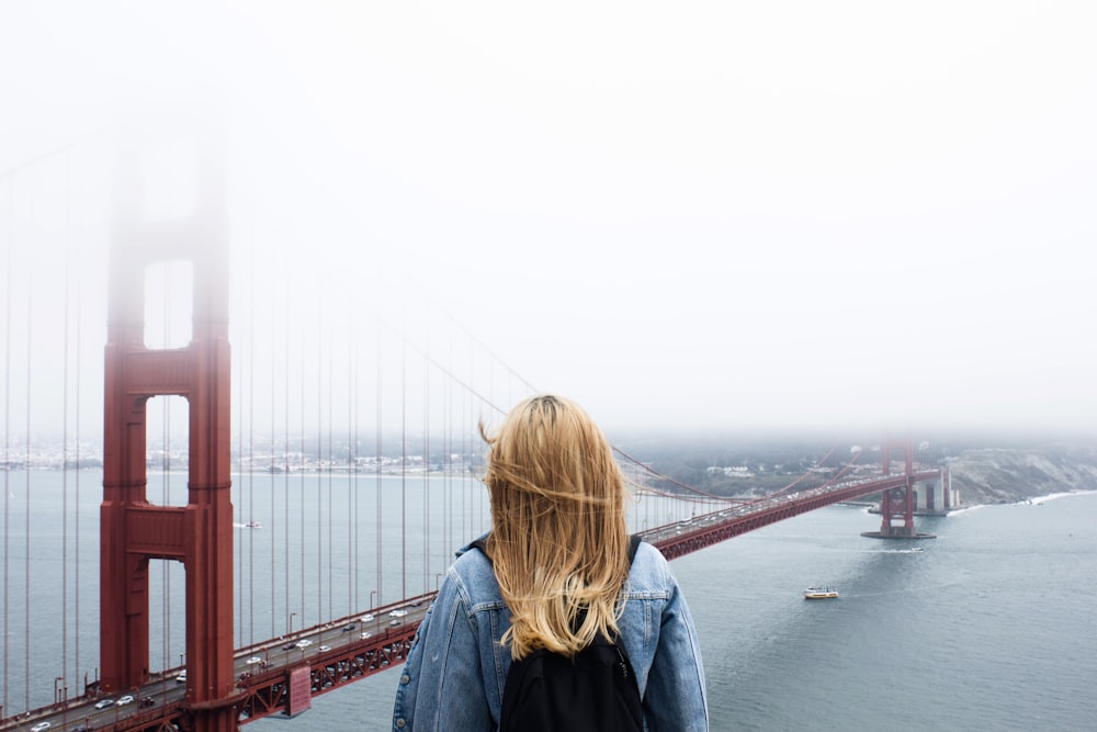 woman facing Golden Gate Bridge