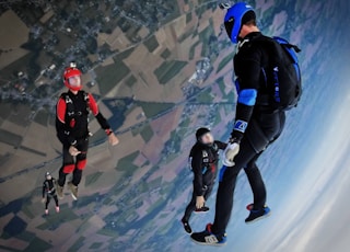 aerial photography of three people skydiving