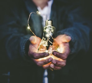 man holding incandescent bulb