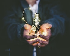 man holding incandescent bulb