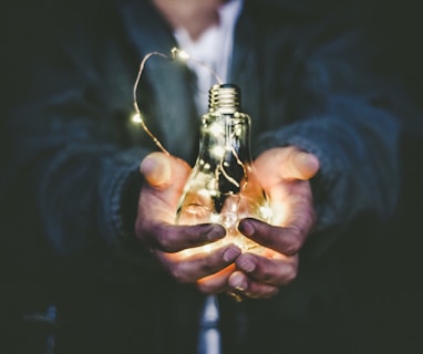 man holding incandescent bulb