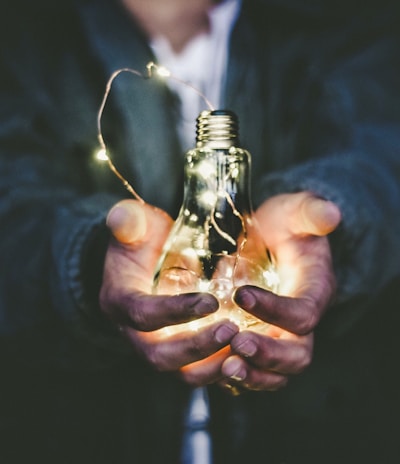 man holding incandescent bulb