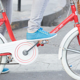 A rider shifting gears on a bike wearing stylish sneakers protected by the gear shield.
